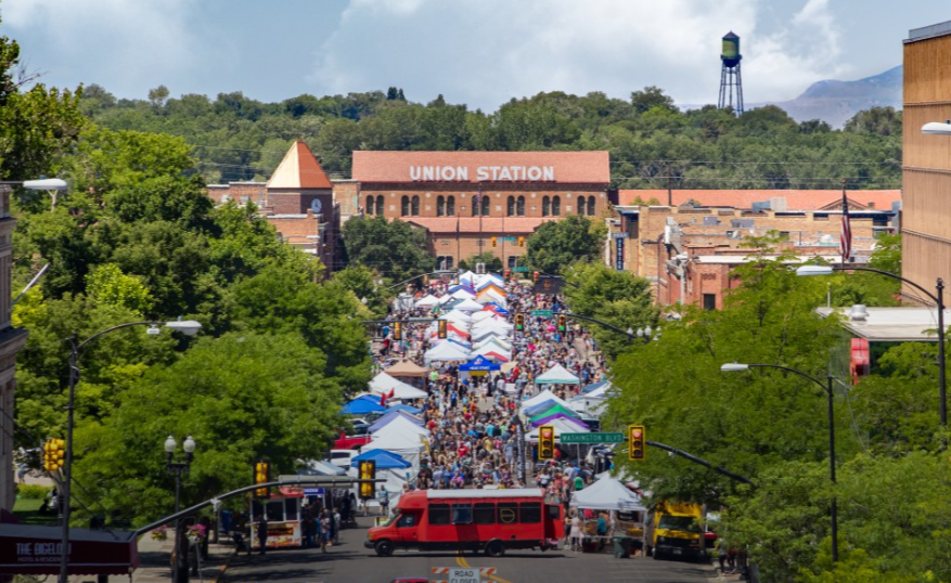 Crowded downtown Ogden farmer's market stretching toward Union Station on a summer day
