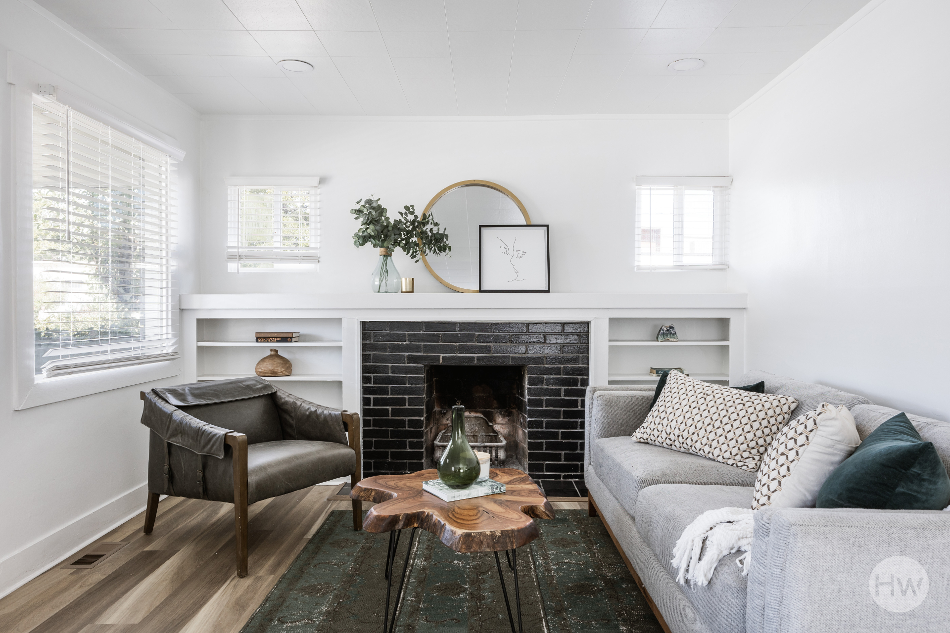 Bright living room with a black brick fireplace